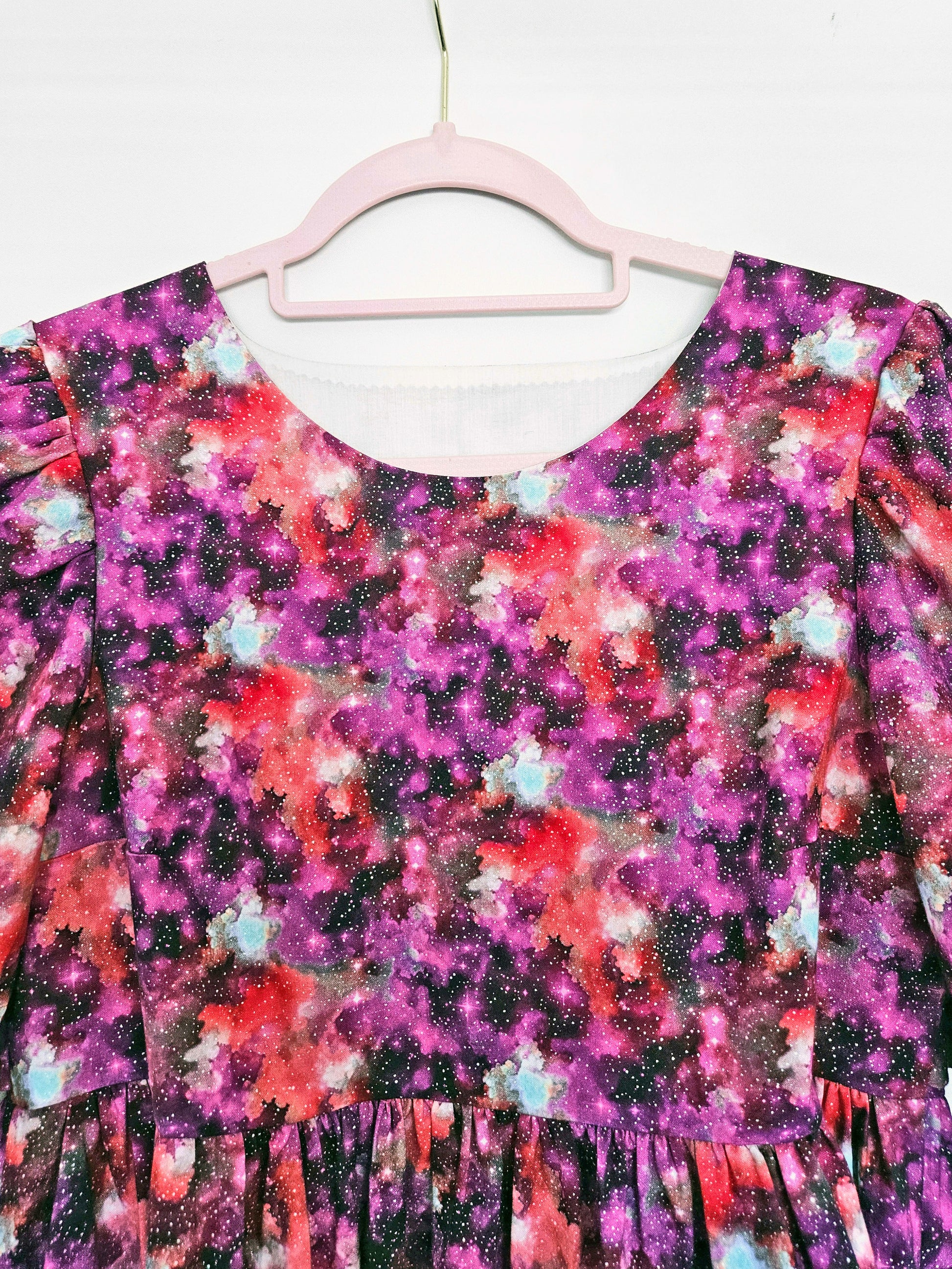 Pink and purple space print dress, close-up on bodice