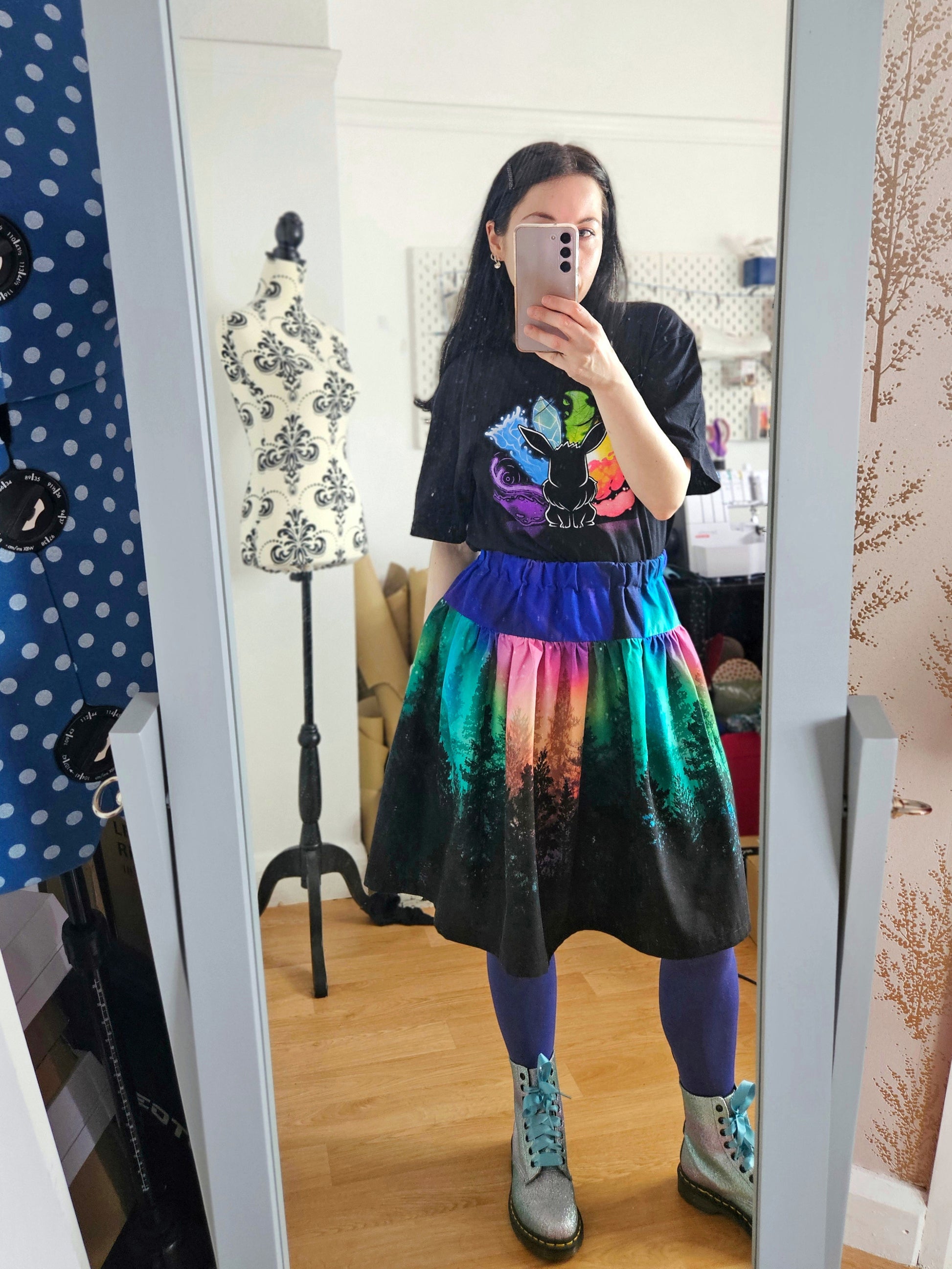Woman wearing skirt with colourful aurora print
