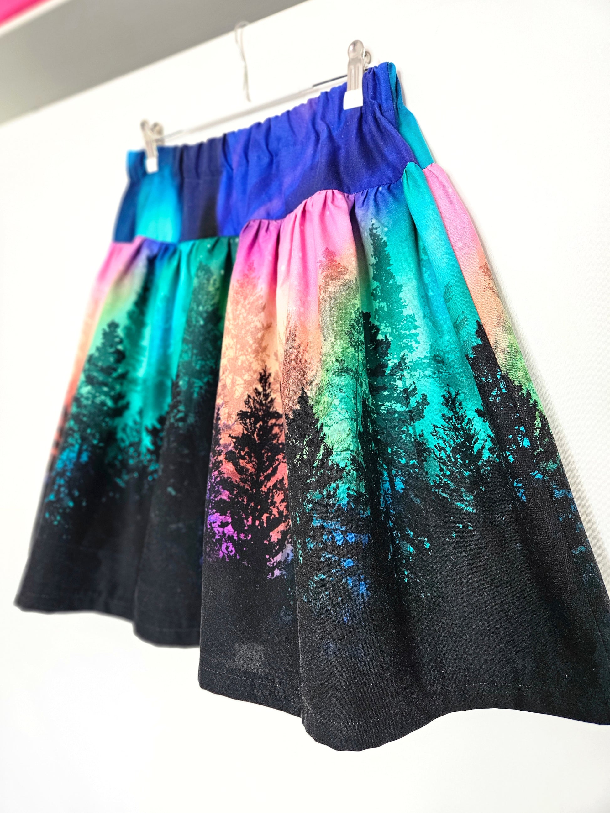 Skirt with colourful aurora print against a white background