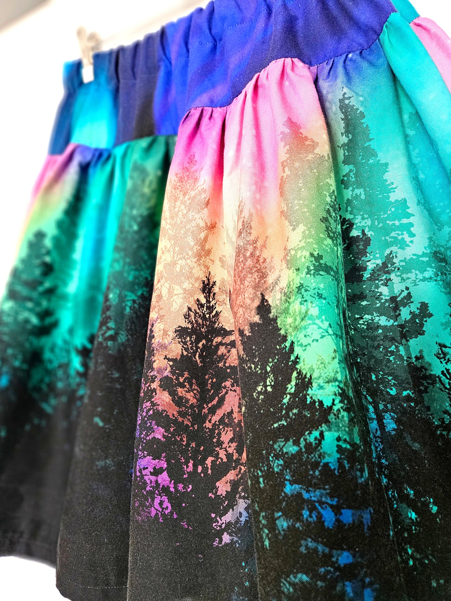 Skirt with colourful aurora print against a white background