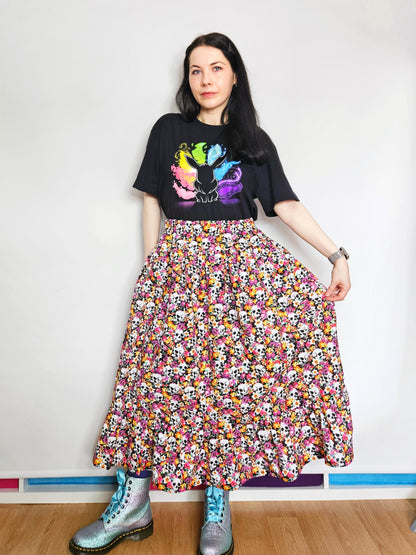 Woman wearing a skirt with colourful skull and floral pattern