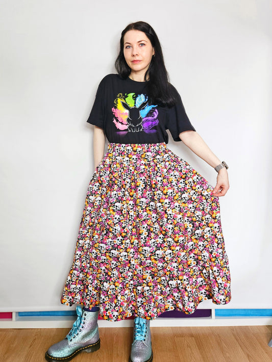 Woman wearing a skirt with colourful skull and floral pattern