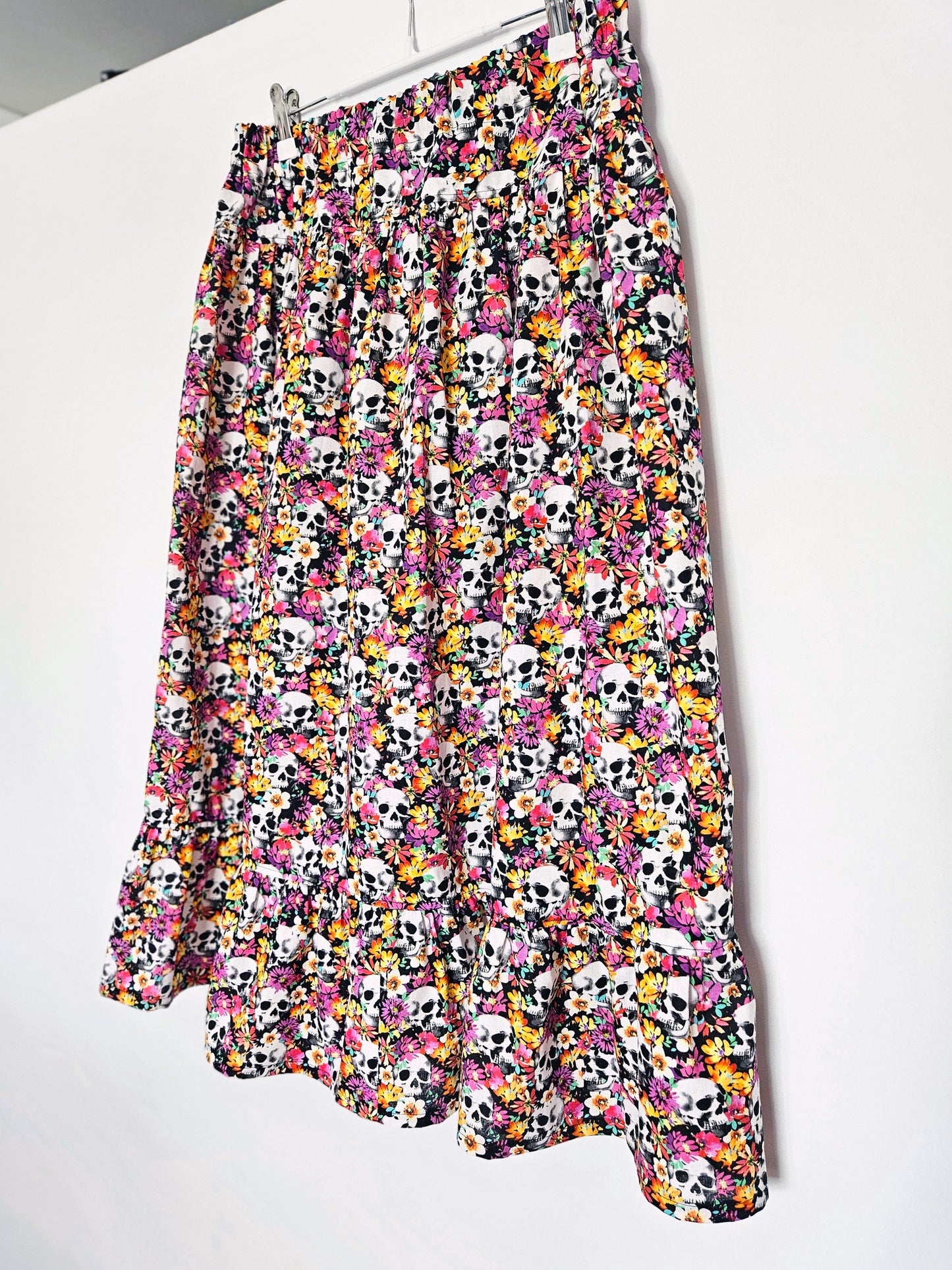 Skirt with colourful skull and floral pattern on a white background