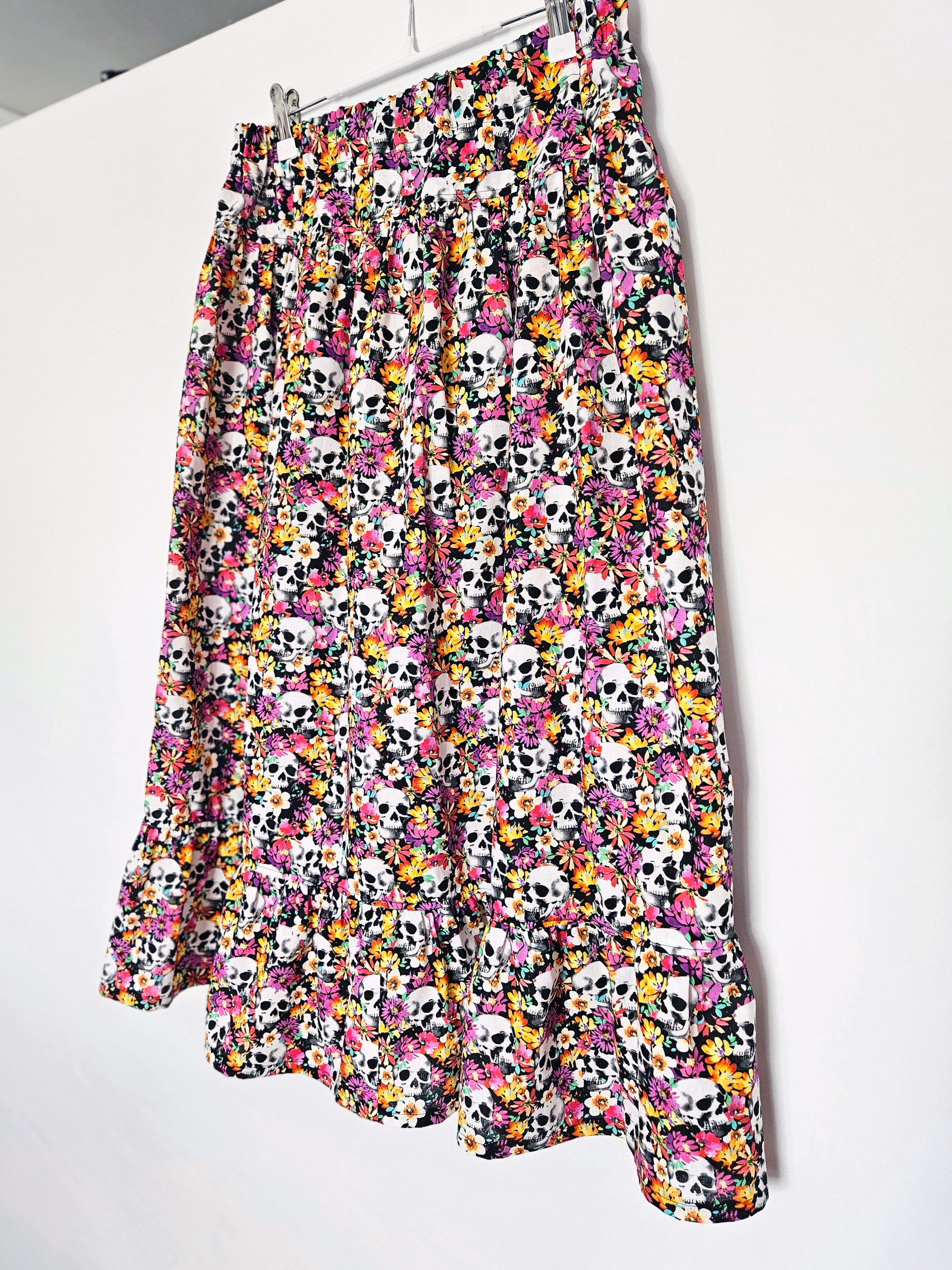 Skirt with colourful skull and floral pattern on a white background
