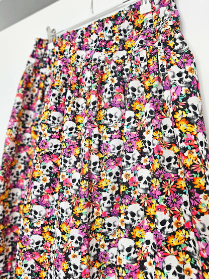 Skirt with colourful skull and floral pattern on a white background
