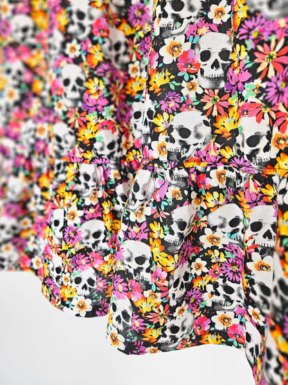 Close up of a skirt with colourful skull and floral pattern