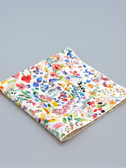 Colourful floral patterned pocket square on a grey background