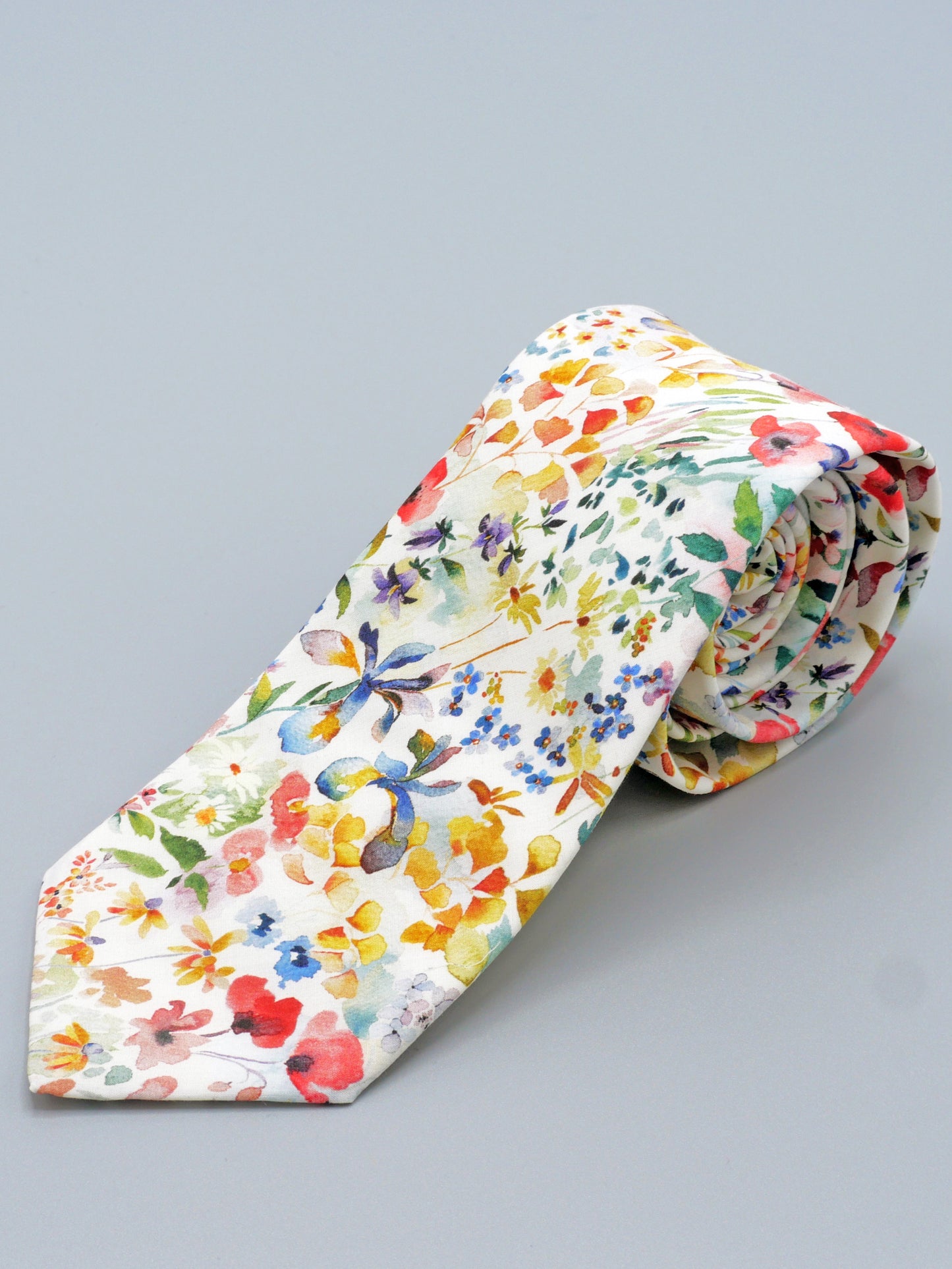 Floral watercolour style patterned tie on a grey background