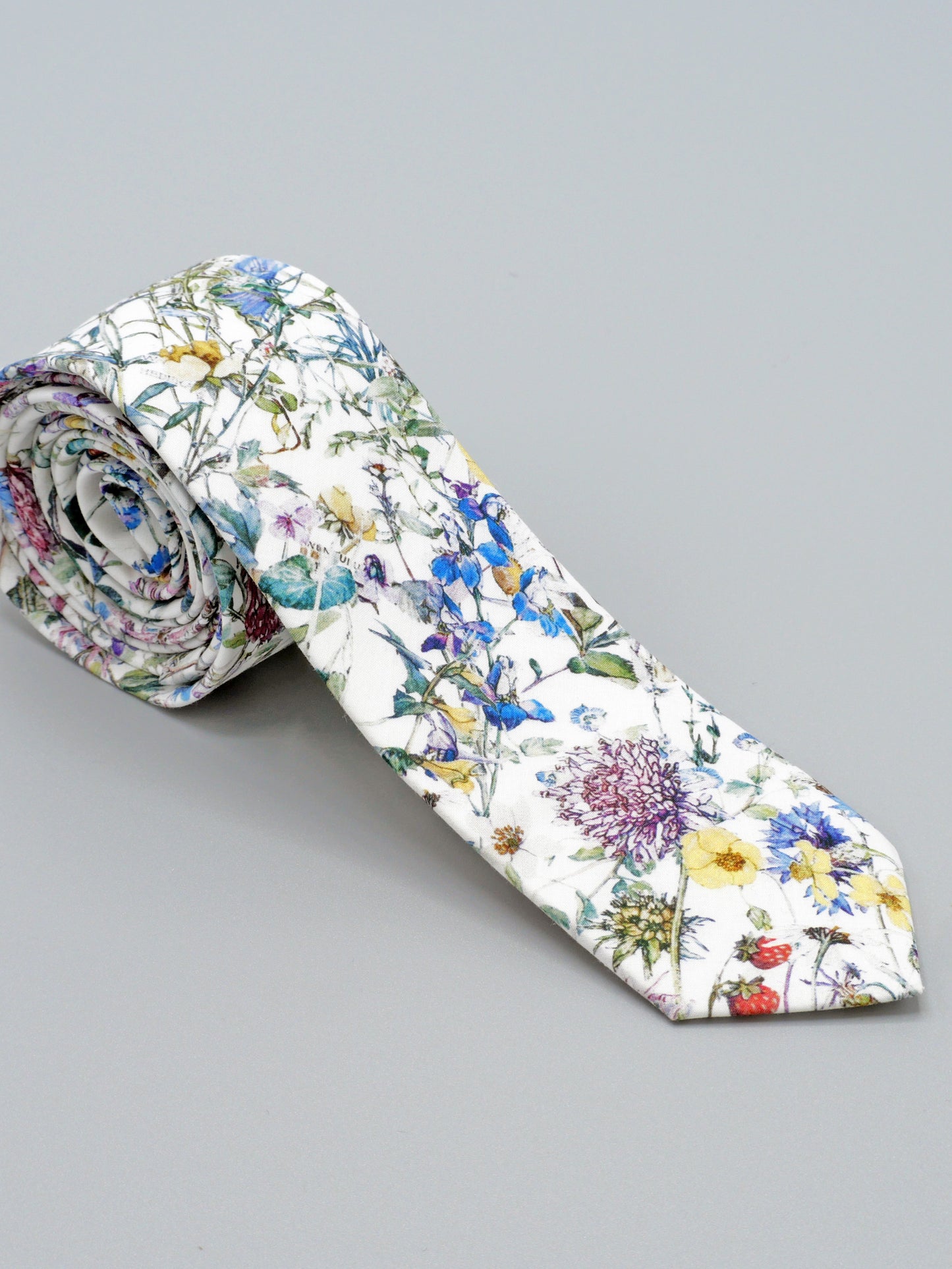 Floral-patterned tie on a grey background