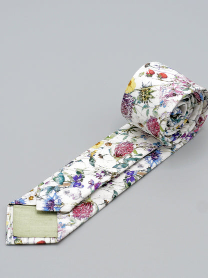 Floral-patterned tie with pale green lined tips on a grey background