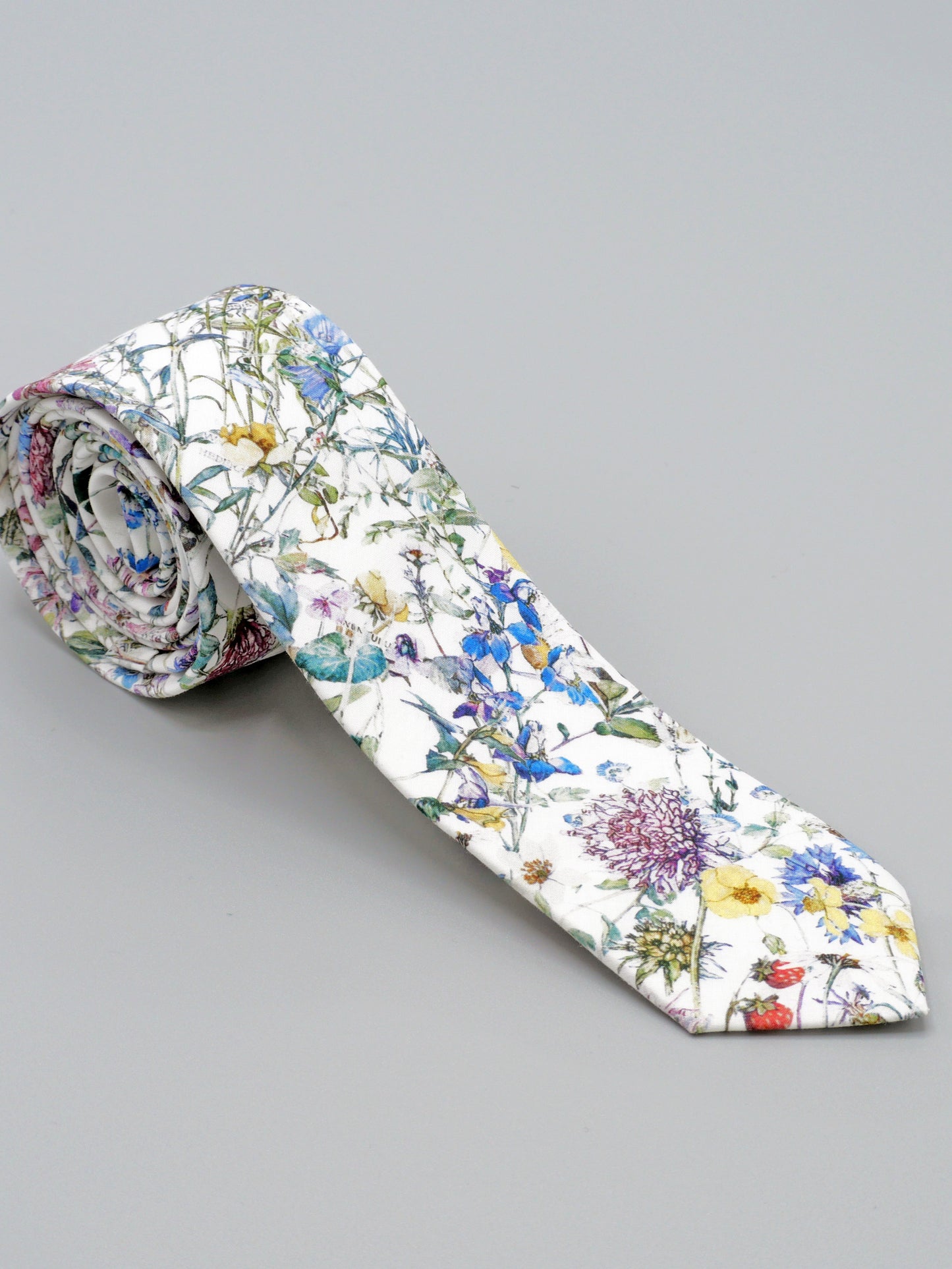 Floral-patterned tie on a grey background
