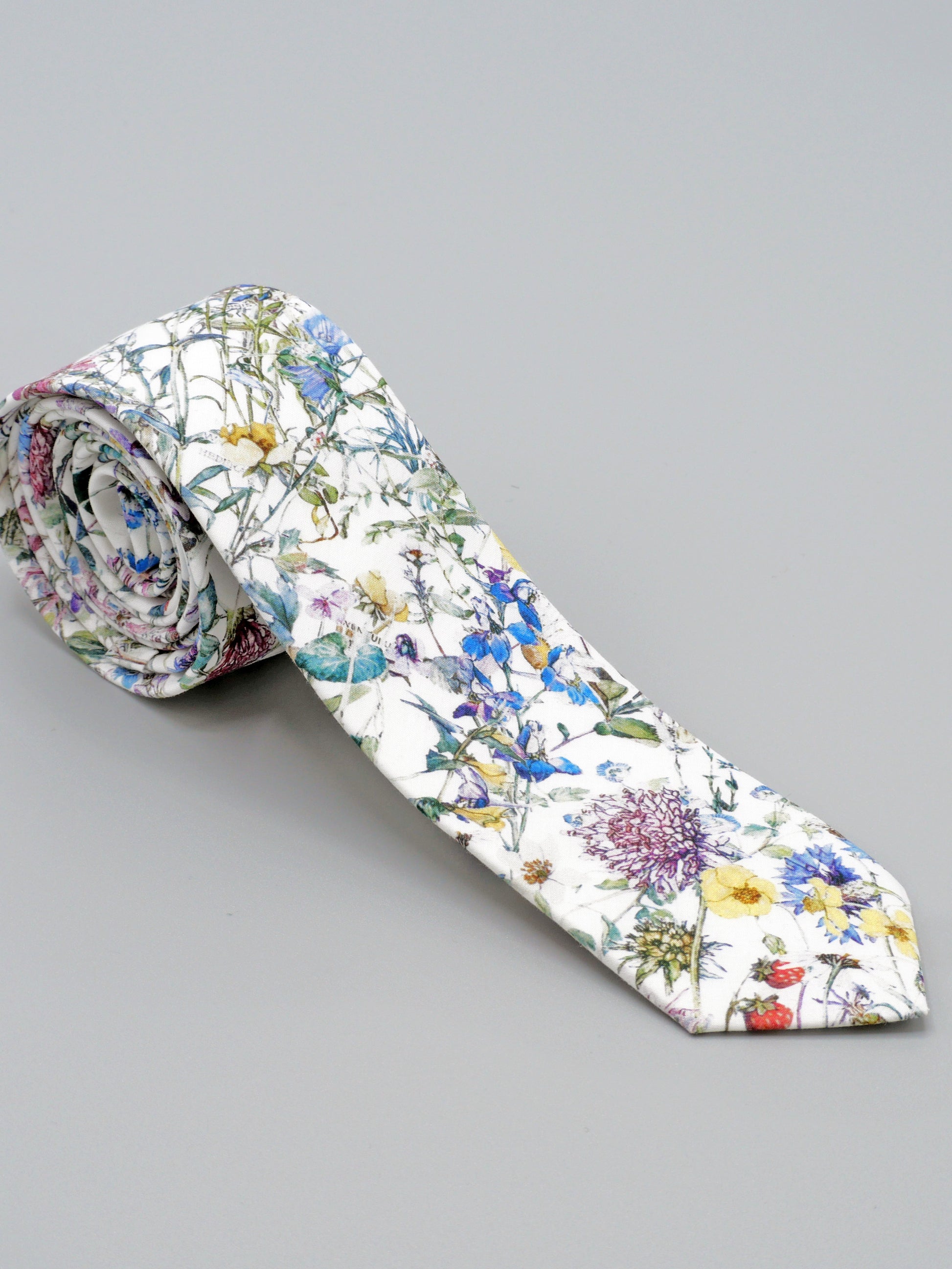Floral-patterned tie on a grey background