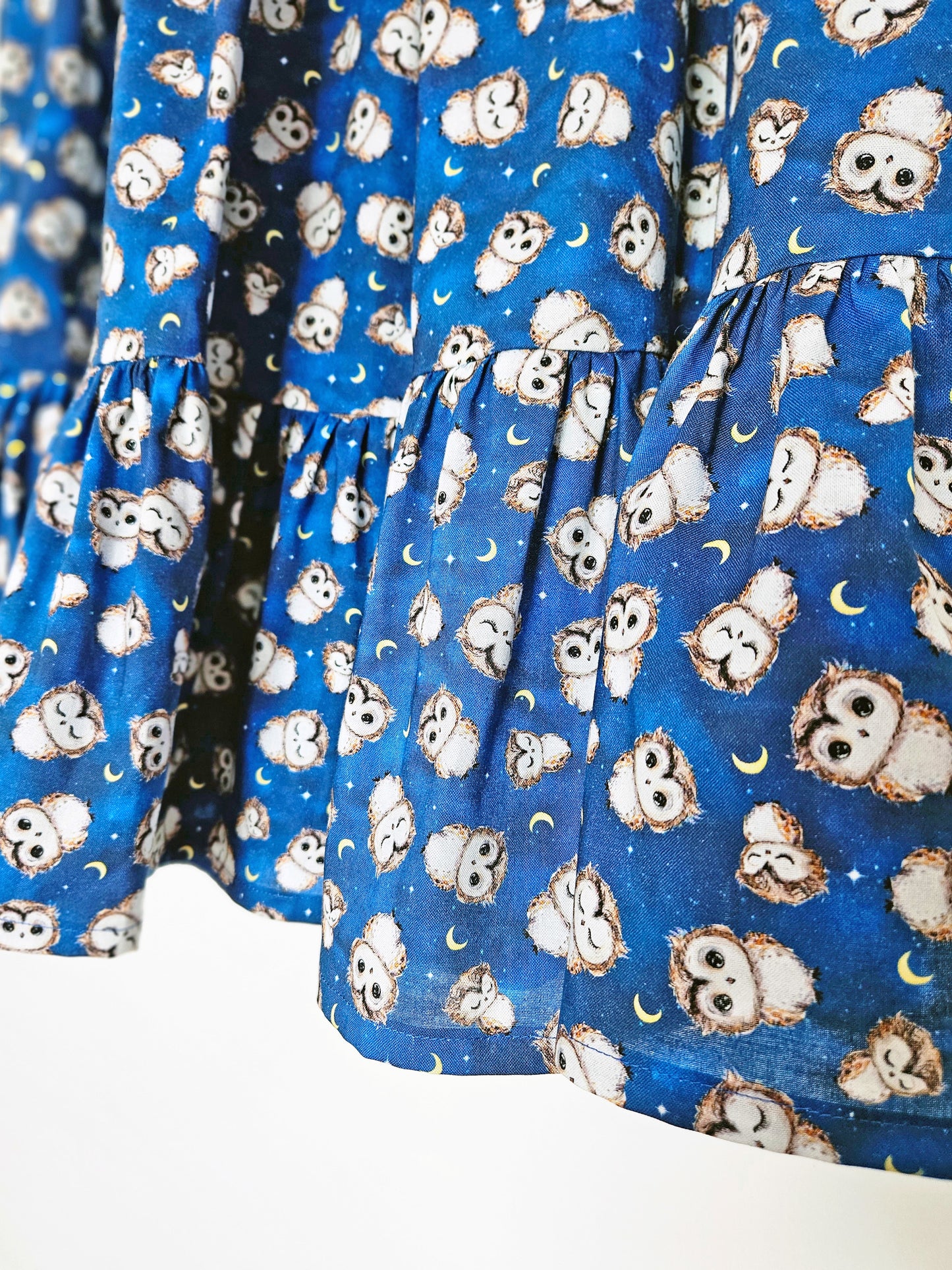 close up of a blue owl print skirt
