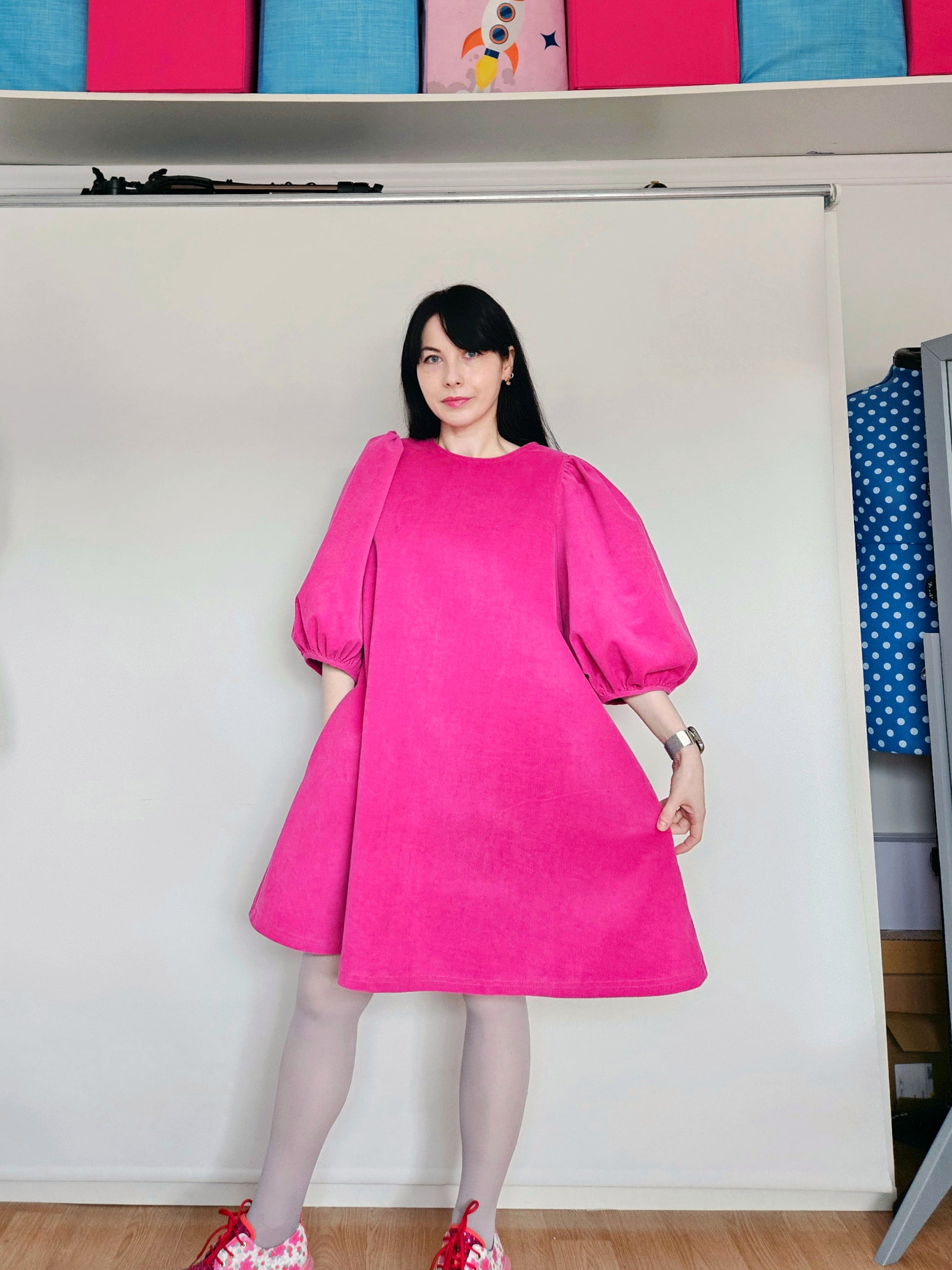 Woman wearing a bright pink dress.