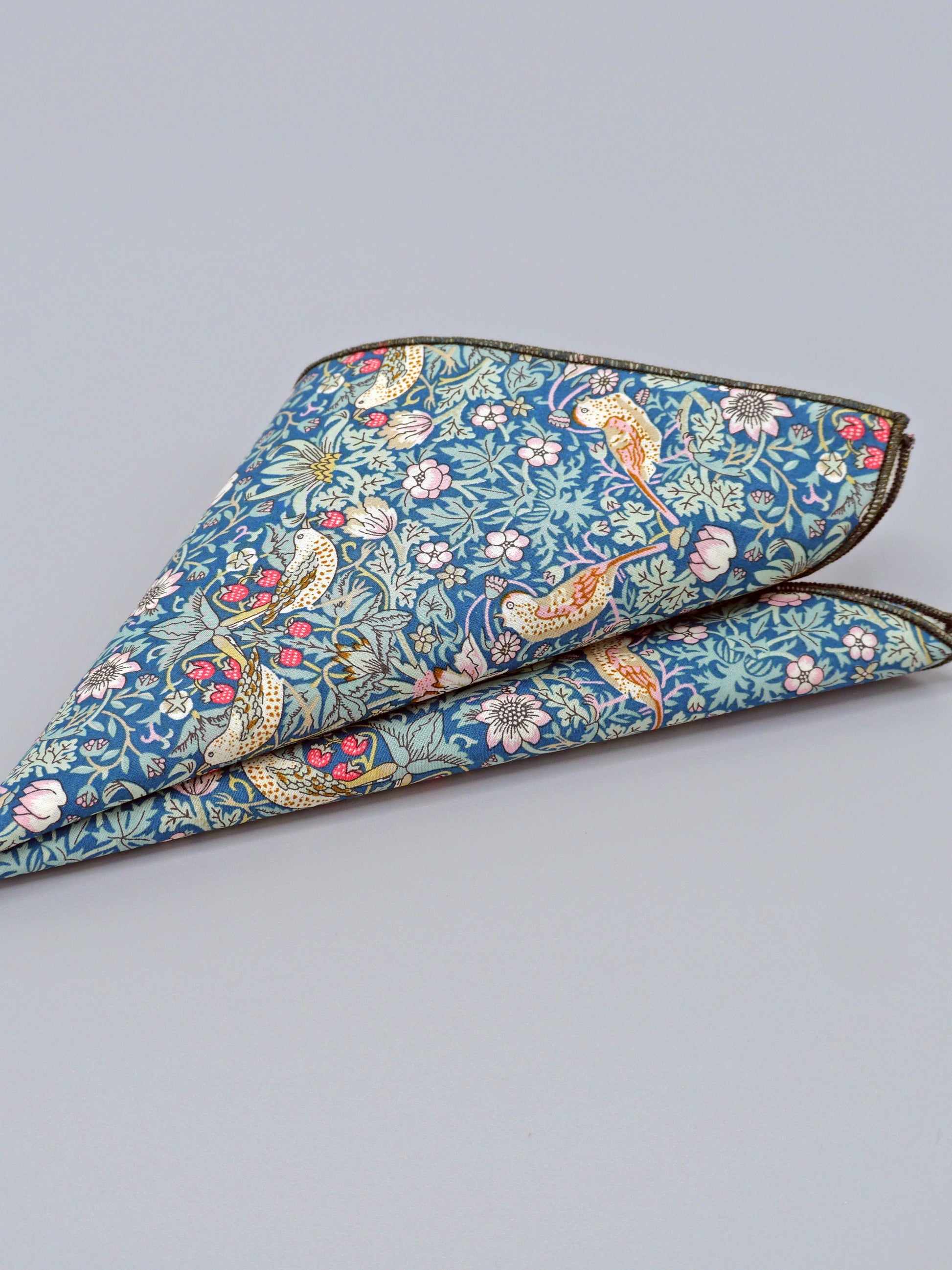 William Morris Strawberry Thief print floral patterned pocket square with a bird and strawberry motif folded into a triangle