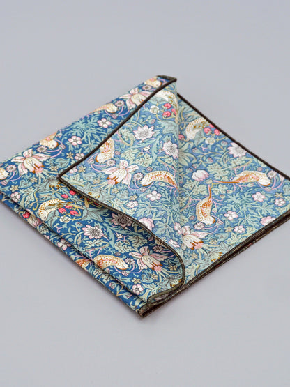 William Morris Strawberry Thief print floral patterned pocket square with a bird and strawberry motif, with one corner folded over