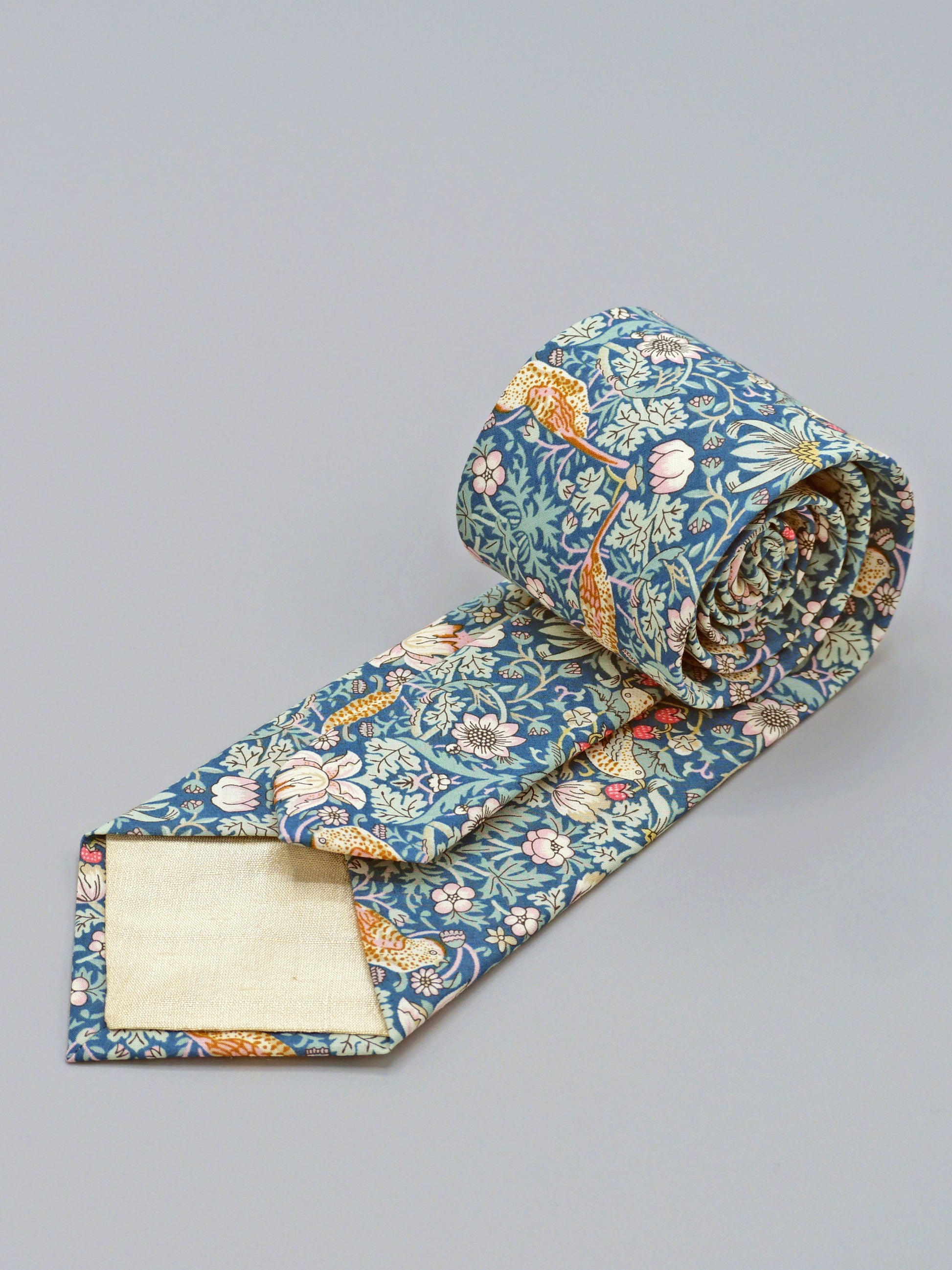 William Morris Strawberry Thief print floral patterned tie with a bird and strawberry motif and cream lining