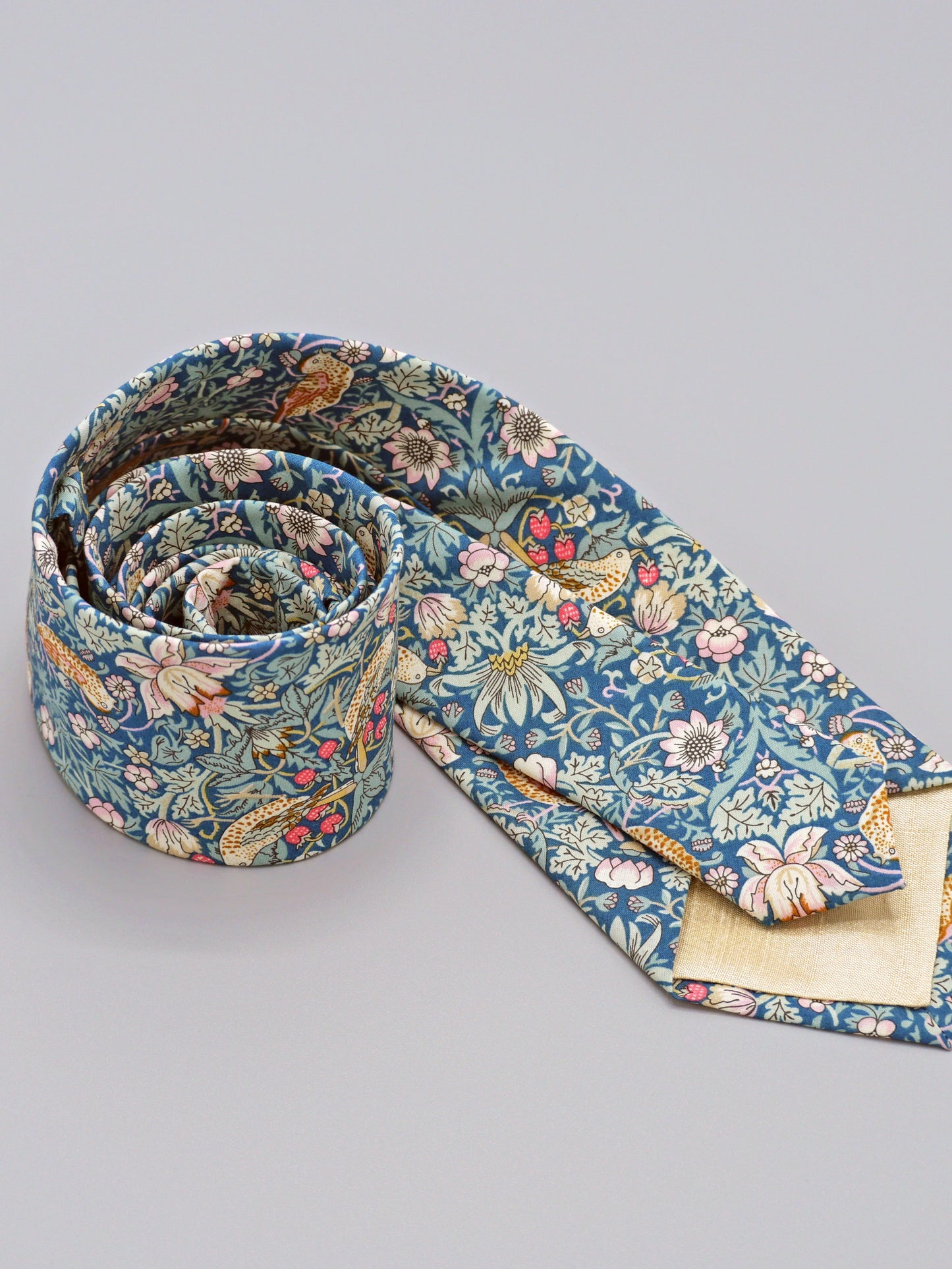 William Morris Strawberry Thief print floral patterned tie with a bird and strawberry motif and cream lining