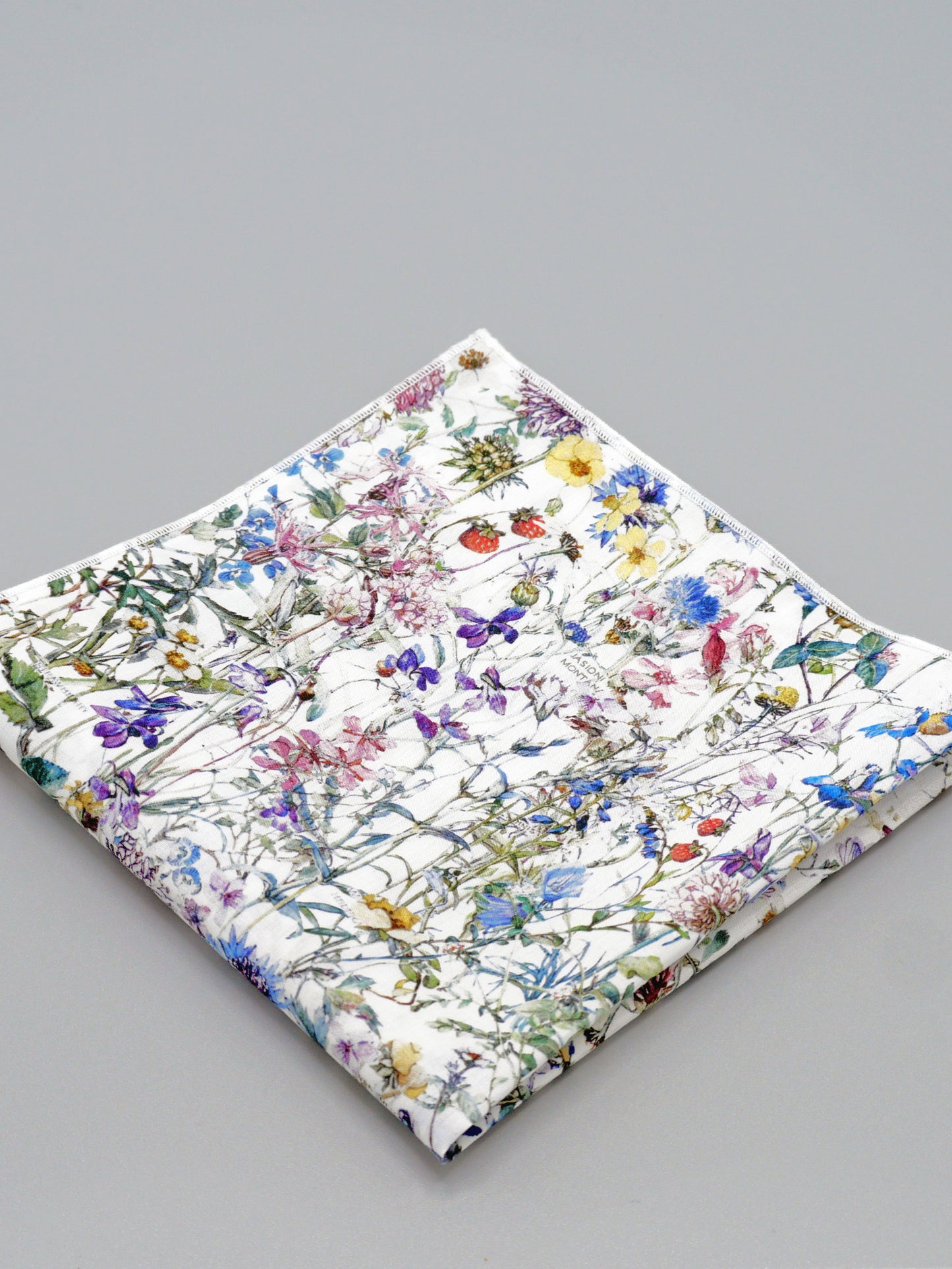 Floral patterned pocket square on a grey background