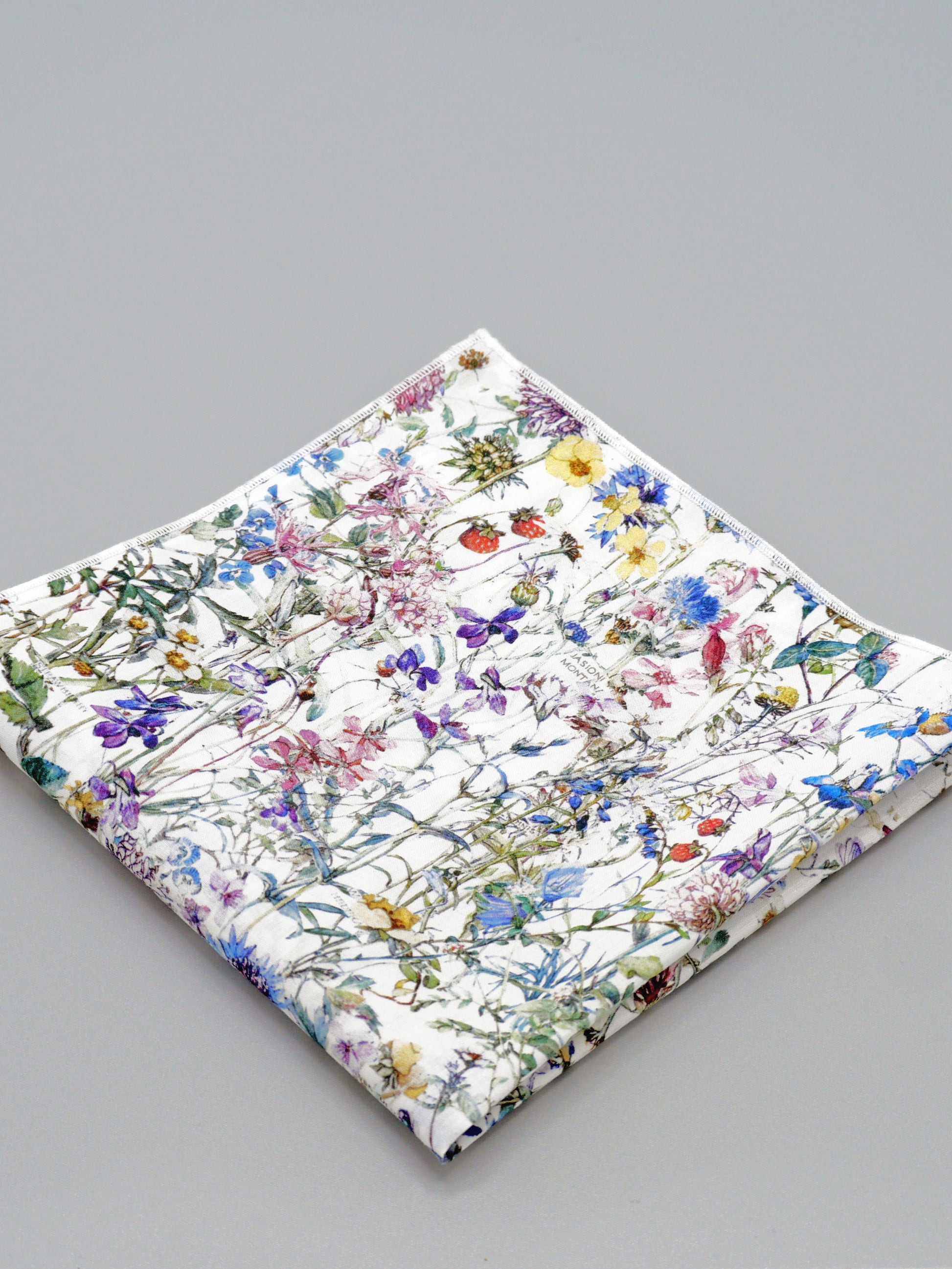 Floral patterned pocket square on a grey background