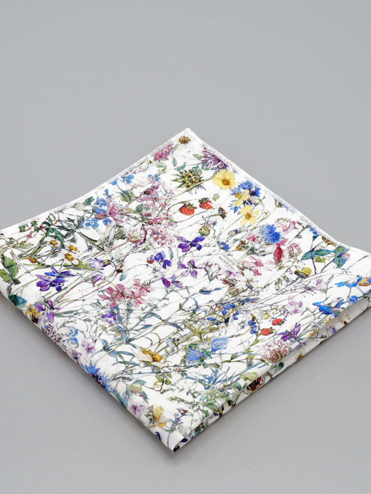 Floral patterned pocket square on a grey background